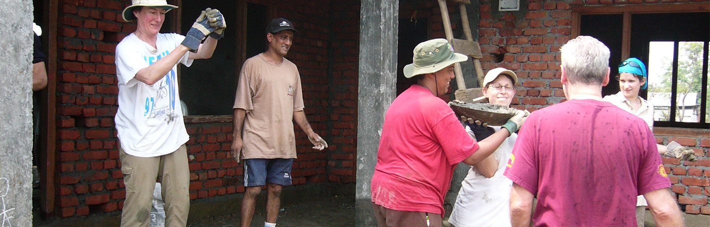 volunteers constructing an orphanage building